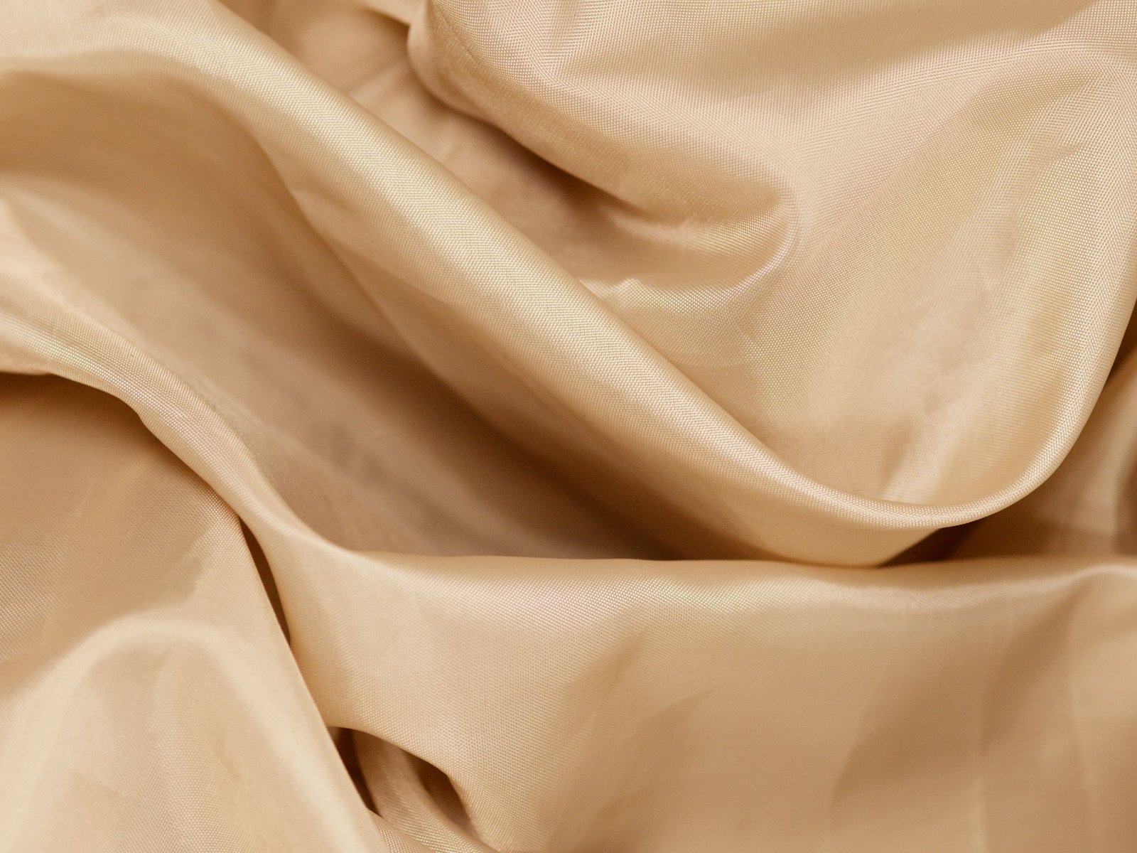 Folds of champagne silk in soft light